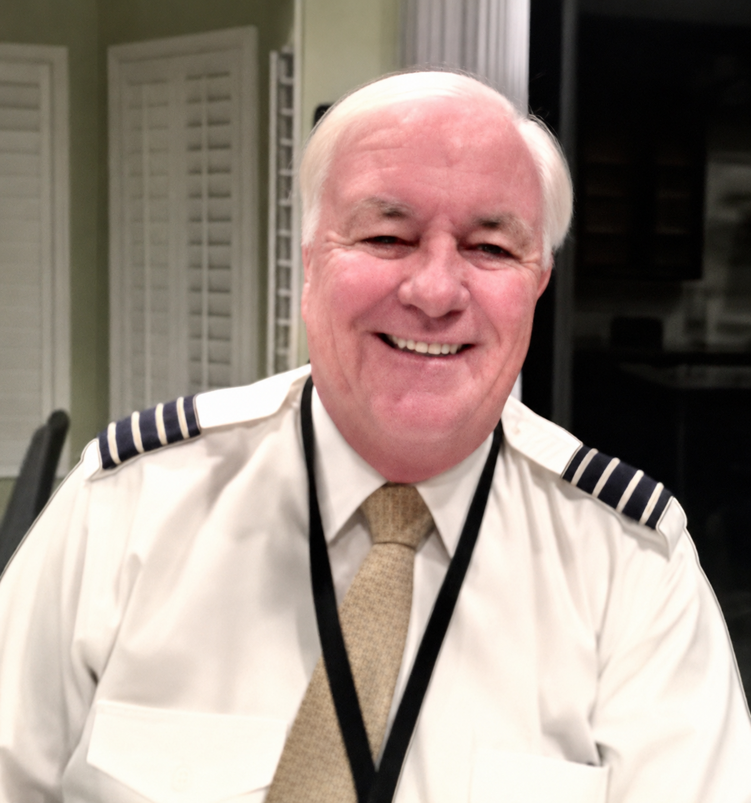 Captain Dan Omerza smiling in his airline captain's uniform
